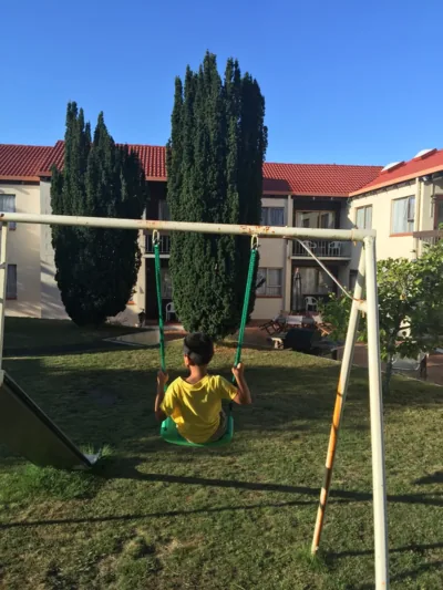 Qian playing on the swing in the motel's backyard